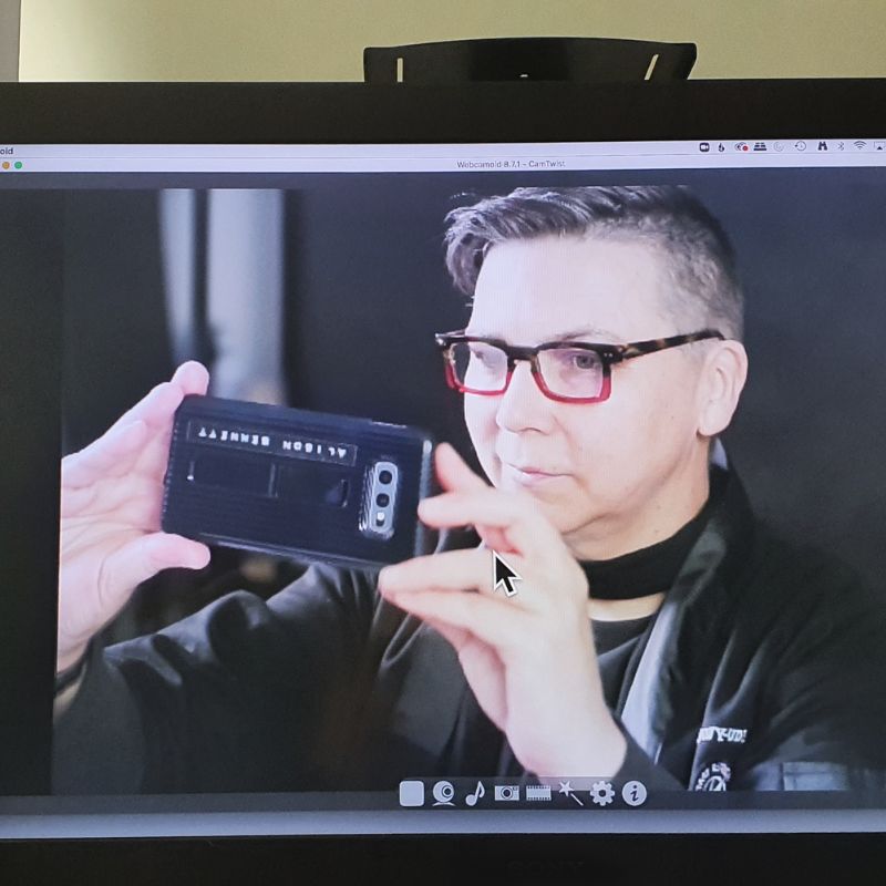A person talking a photo of themselves on a computer screen.