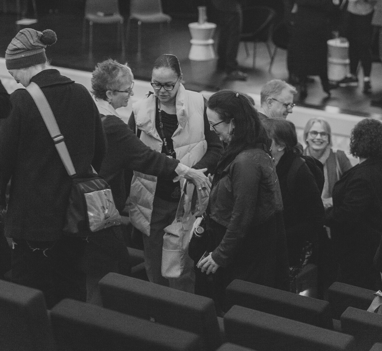 A crowd of people chats after the event.