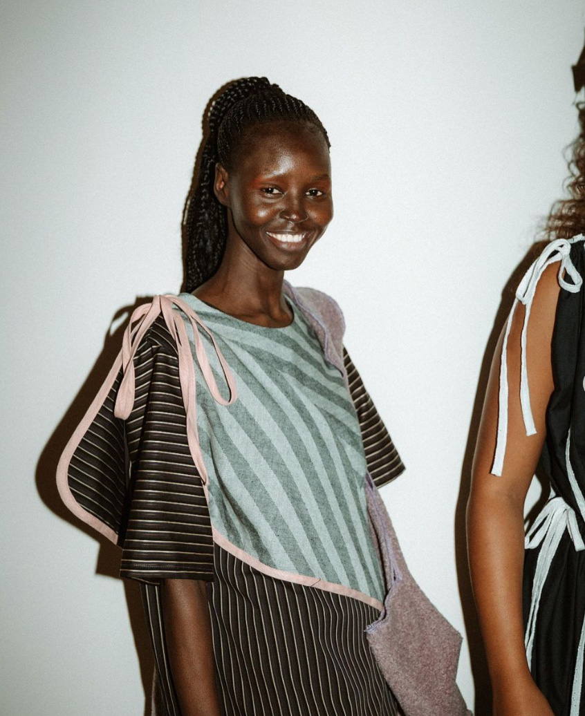 A black model at fashion week smiling