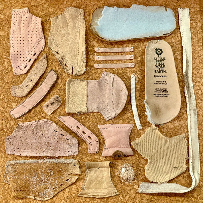 A children's shoe deconstructed into pieces.